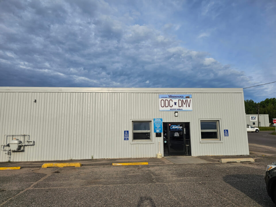 exterior office door ODC DMV office building in Minnesota with cloudy sky